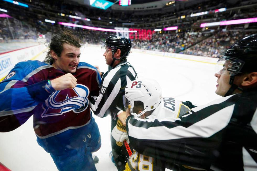 Colorado Avalanche defenseman Dennis Gilbert (48) punches Vegas Golden Knights left wing Willia ...