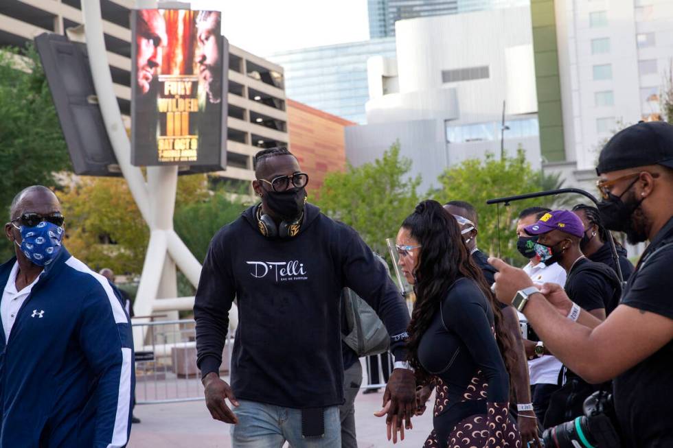 Heavyweight champion Deontay Wilder and his fiancee Telli Swift leave a press conference at Tos ...