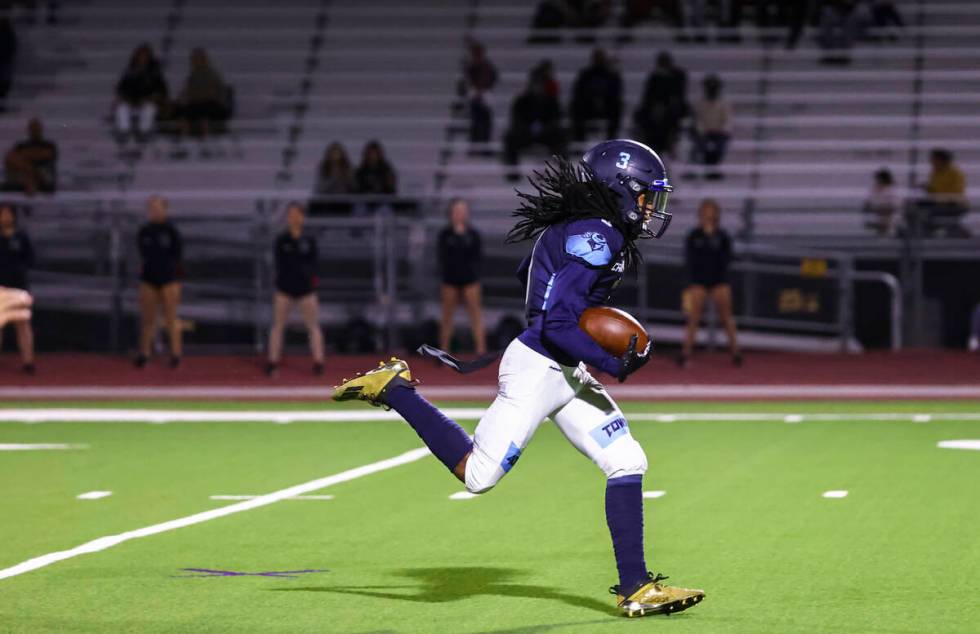 Canyon Springs' Dionn Whittaker (3) runs with the ball after a reception to score a touchdown a ...