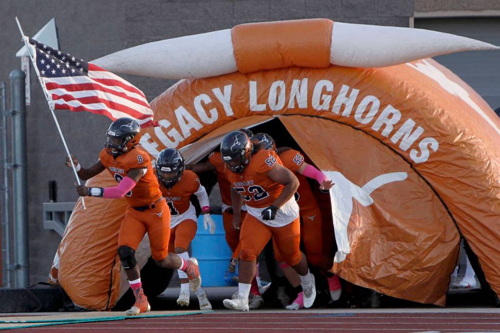 Legacy High School's players run out to the field before a football game against Bishop Gorman ...