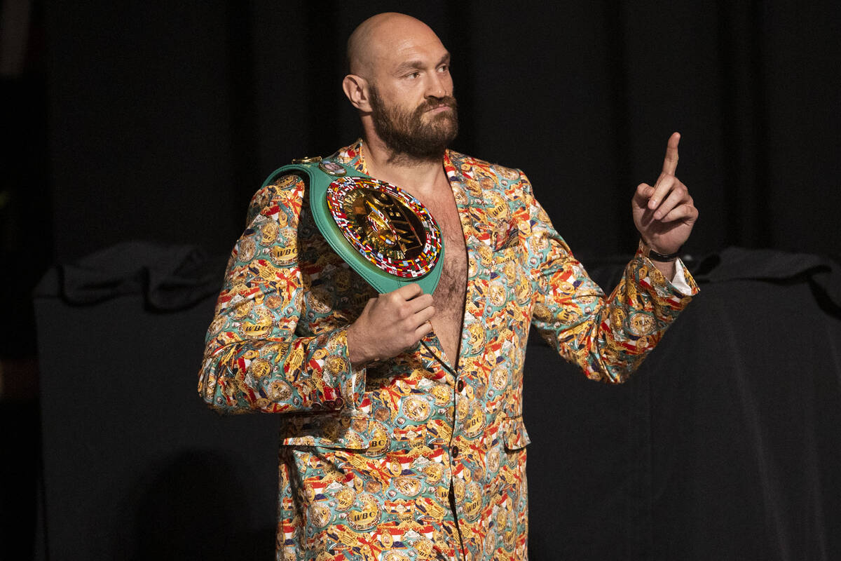 Tyson Fury takes the stage for a press conference in advance of his heavyweight title fight aga ...