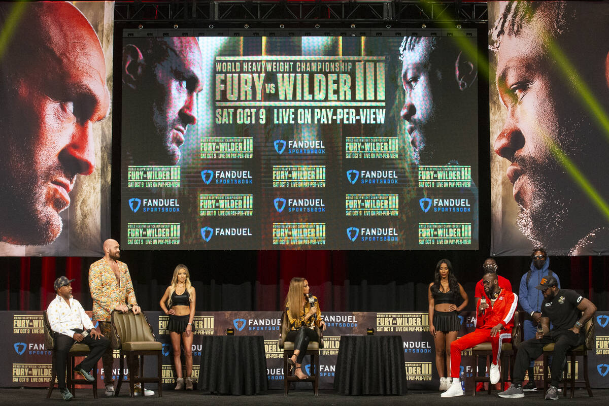 Tyson Fury, left, and Deontay Wilder, participate during a press conference in advance of their ...