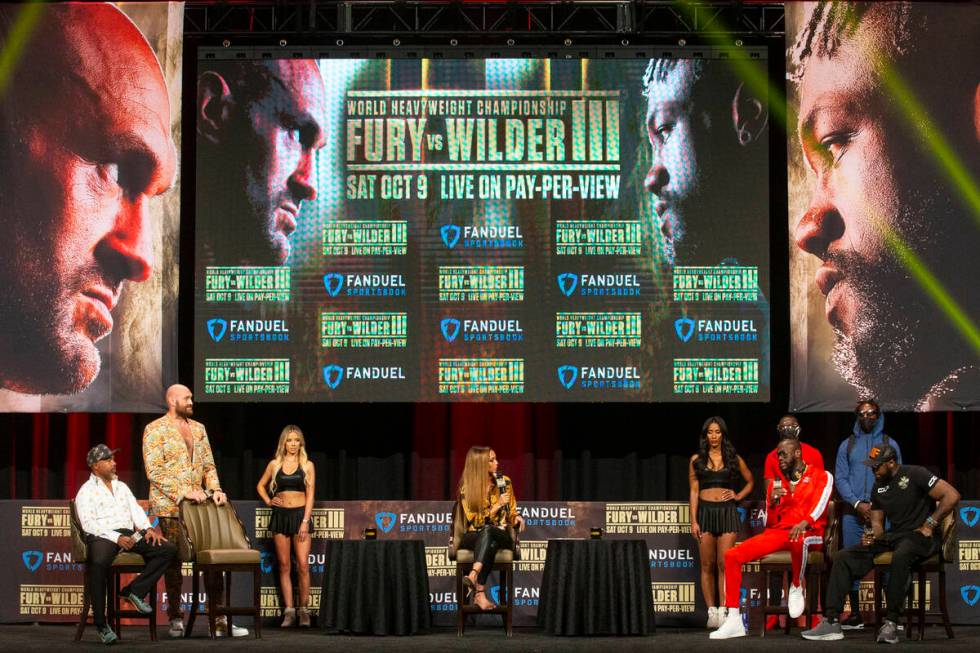 Tyson Fury, left, and Deontay Wilder, participate during a press conference in advance of their ...