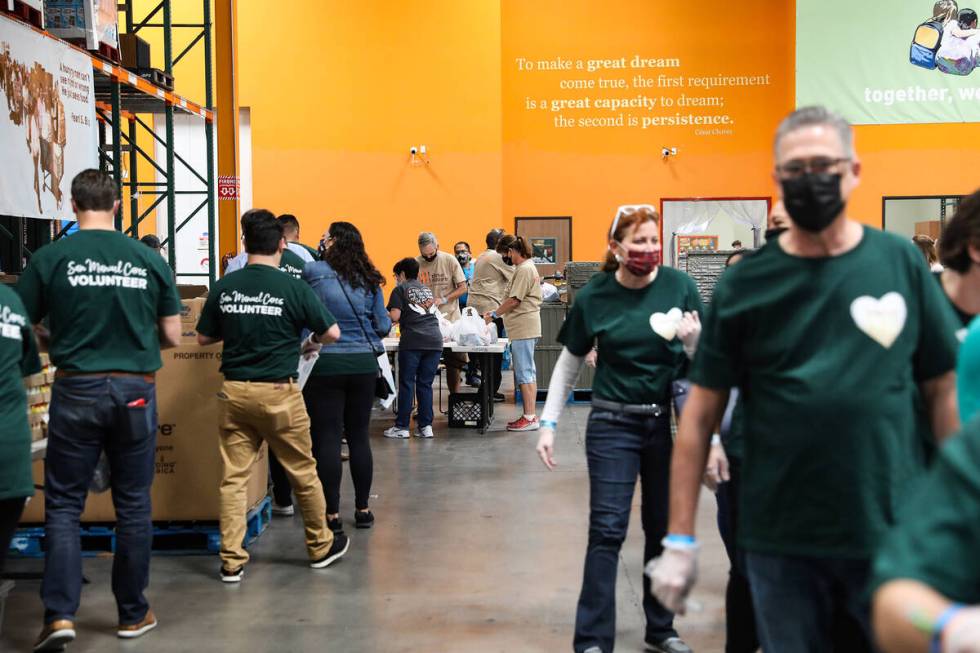 Members of the San Manuel Band of Mission Indians pack bags of food for the BackPack for Kids p ...