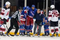 New York Rangers' Ryan Reaves is helped off the ice during the first period of the team's NHL p ...