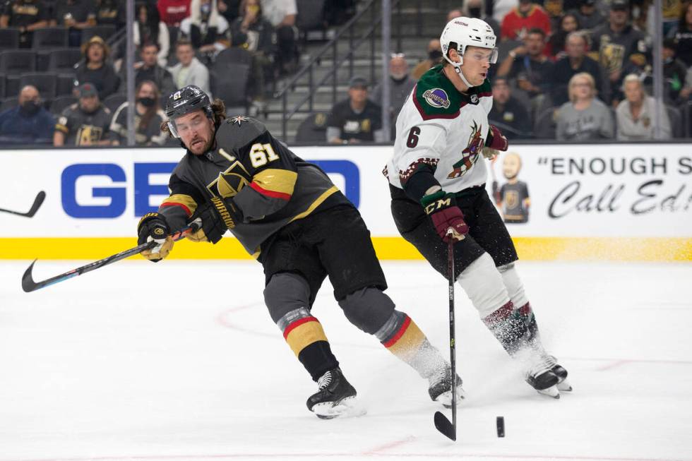 Golden Knights right wing Mark Stone (61) loses control of the puck to Coyotes defenseman Jakob ...