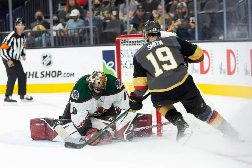 Coyotes goaltender Karel Vejmelka (70) saves a shot on goal by Golden Knights right wing Reilly ...