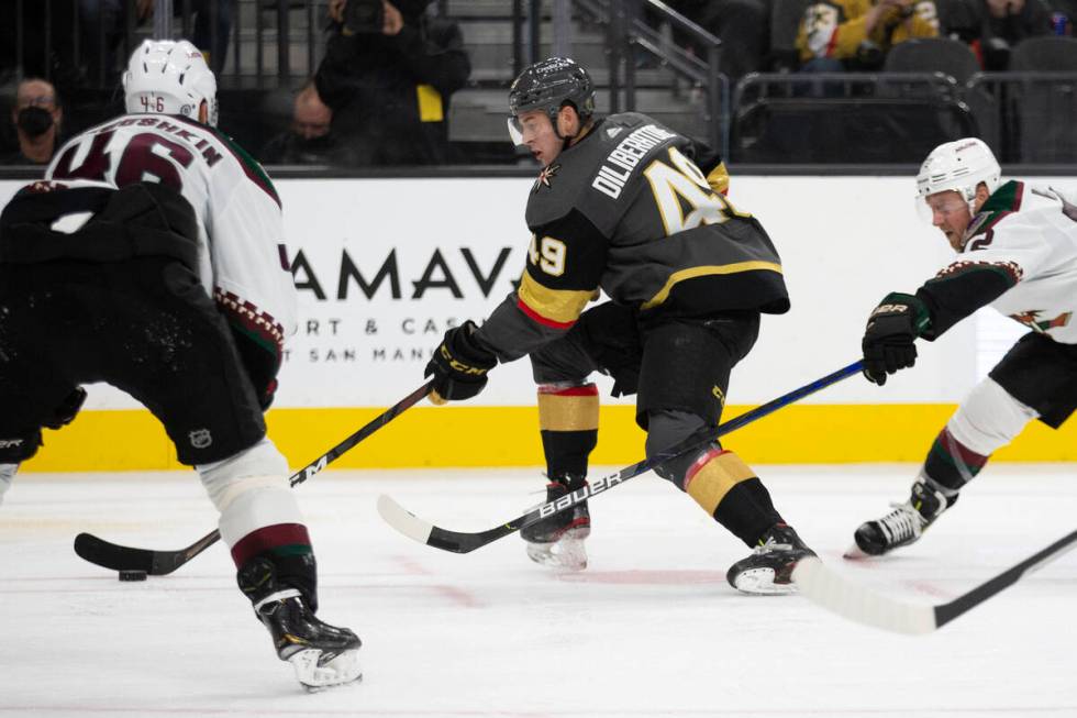 Golden Knights defenseman Peter DiLiberatore (49) skates with the puck as Coyotes center Ilya L ...
