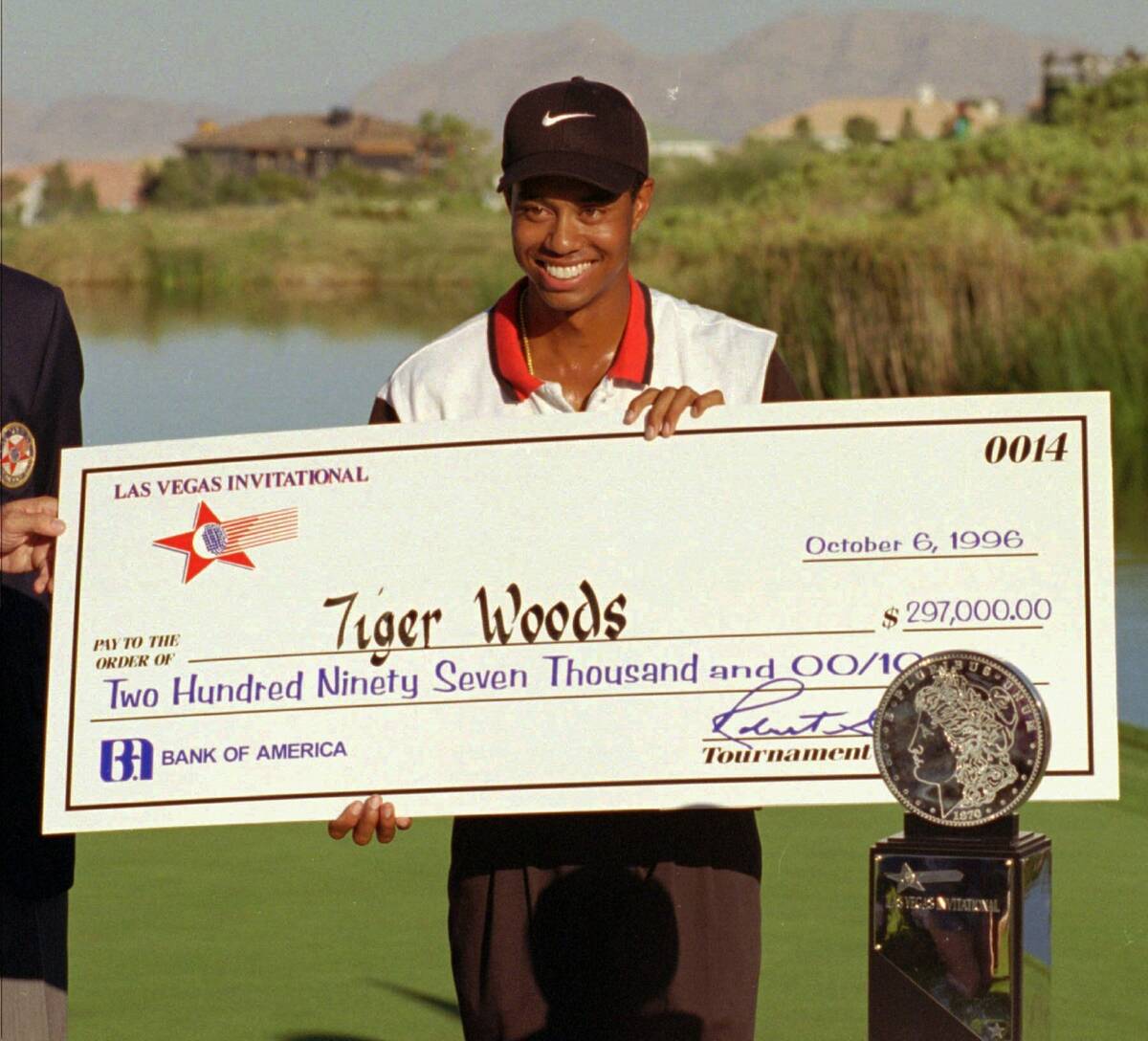 FILE - In this Oct. 6, 1996, file photo, rookie pro golfer Tiger Woods smiles after receiving a ...