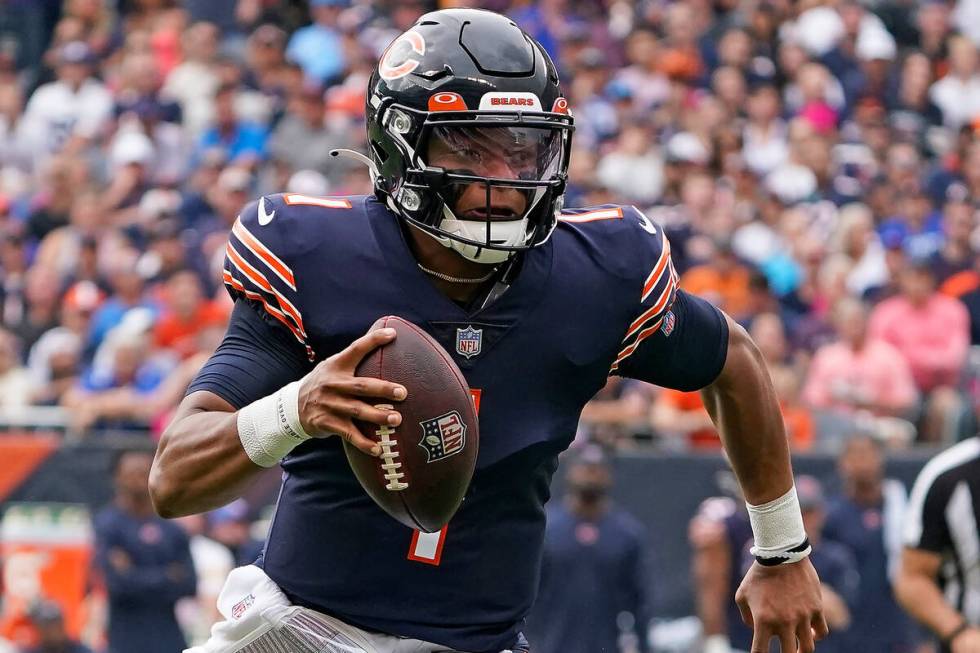 Chicago Bears quarterback Justin Fields (1) runs against the Detroit Lions in the first half du ...