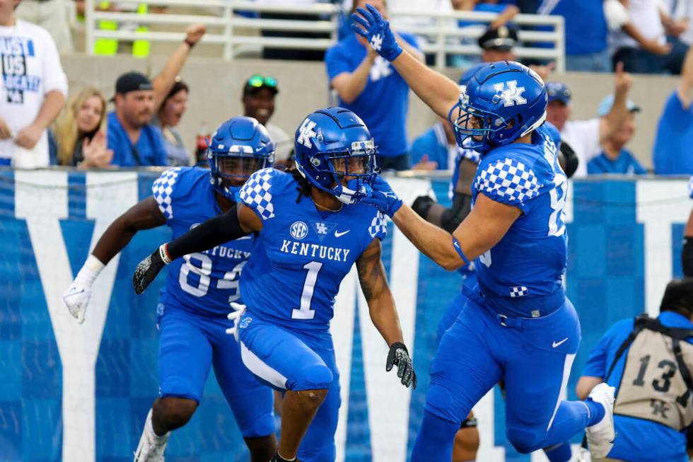 Kentucky wide receiver Wan'Dale Robinson (1) celebrates scoring a touchdown during an NCAA coll ...