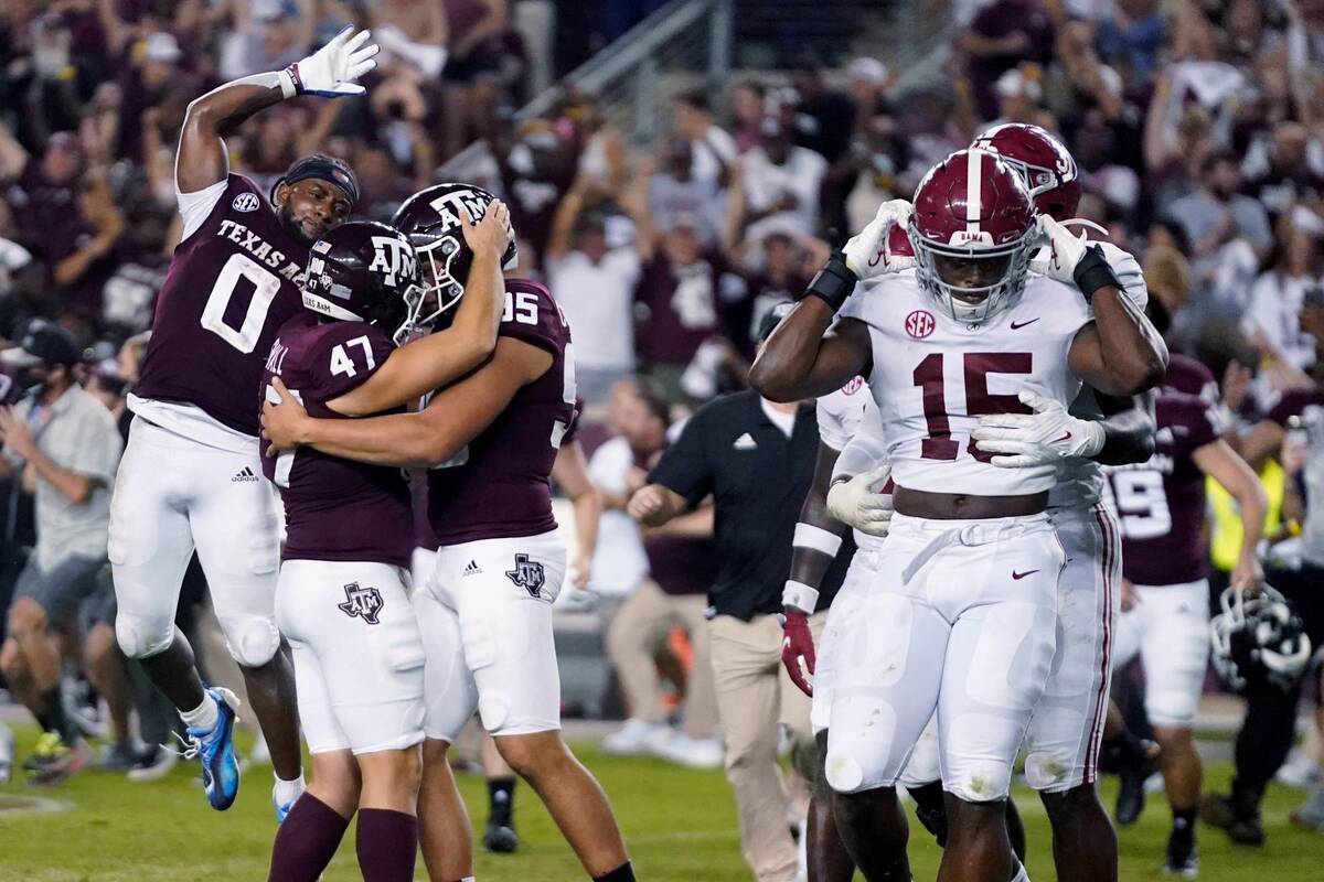 Texas A&M's Seth Small (47) celebrates with Nik Constantinou (95) and Ainias Smith (0) after hi ...