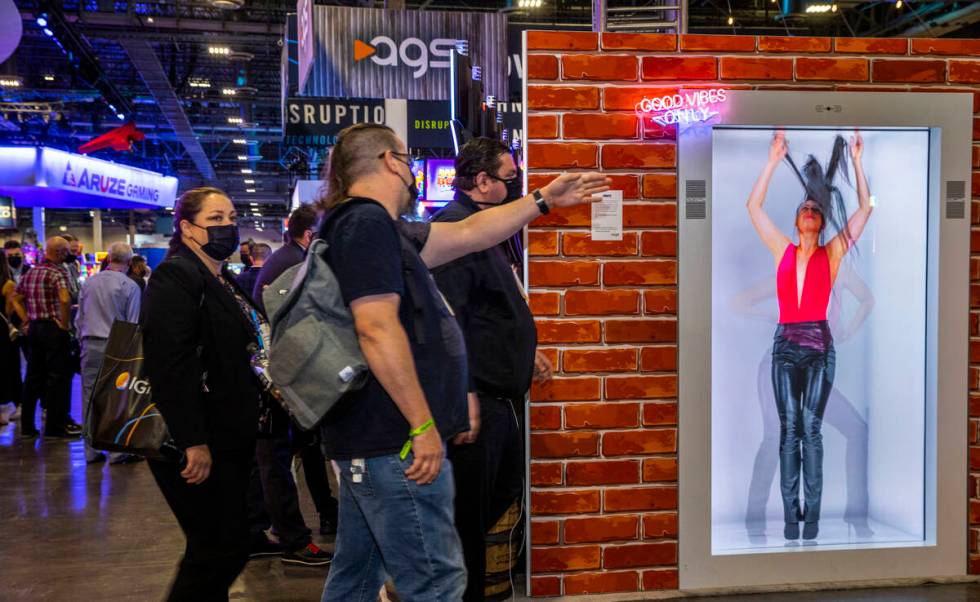 Attendees wander past a new AGS Portl hologram unit during day 3 at the Global Gaming Expo 2021 ...