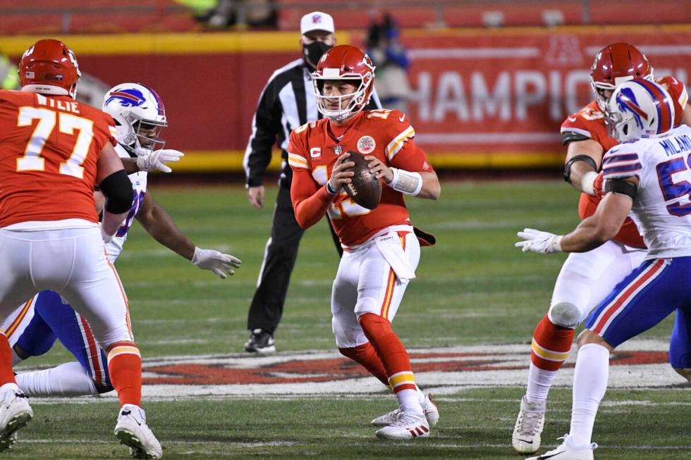 Kansas City Chiefs quarterback Patrick Mahomes scrambles during the first half of the NFL AFC c ...