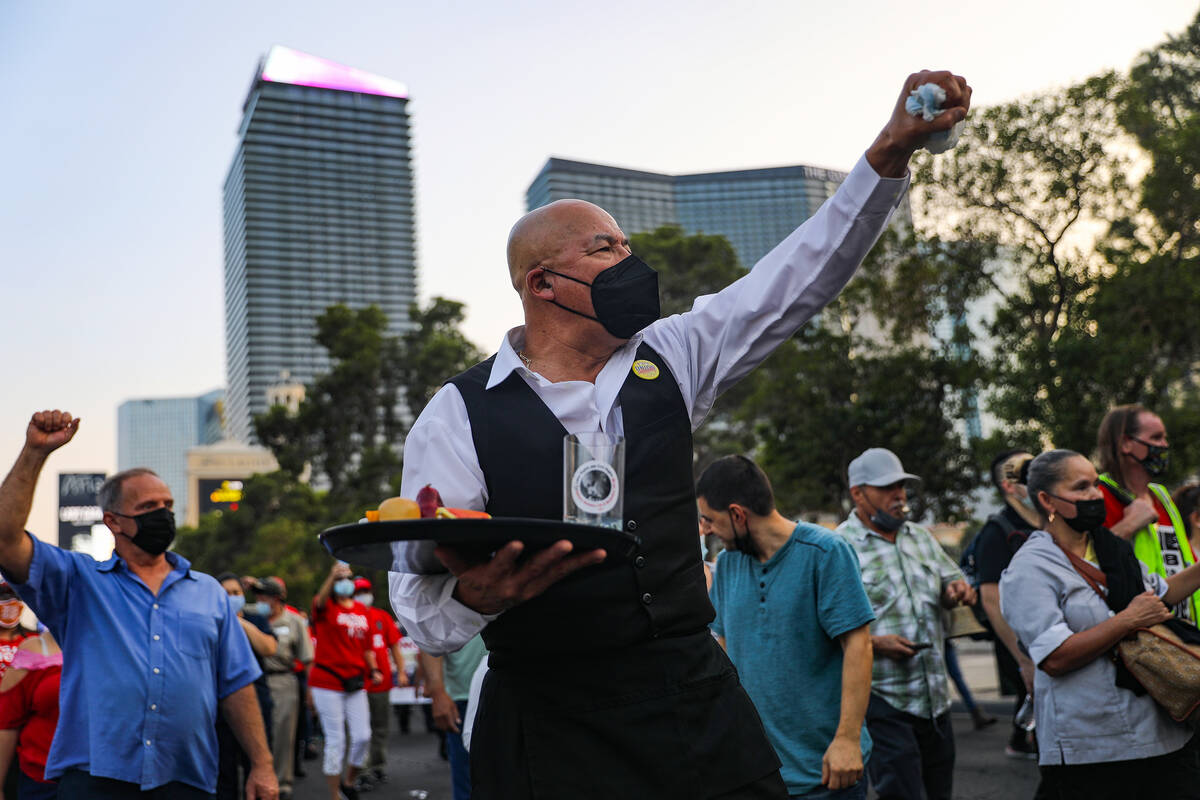 Jose Rivera chants as he marches with other members of the Culinary Workers Union Local 226 to ...