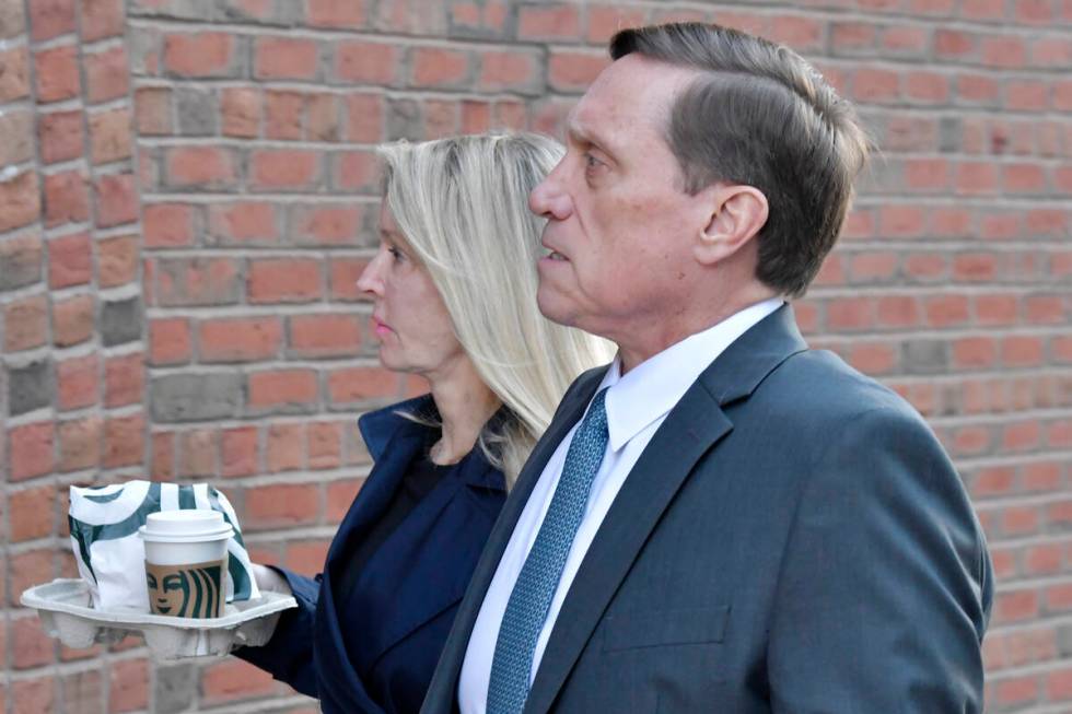 John Wilson and his wife arrive at federal court Thursday, Oct. 7, 2021, in Boston. Wilson and ...