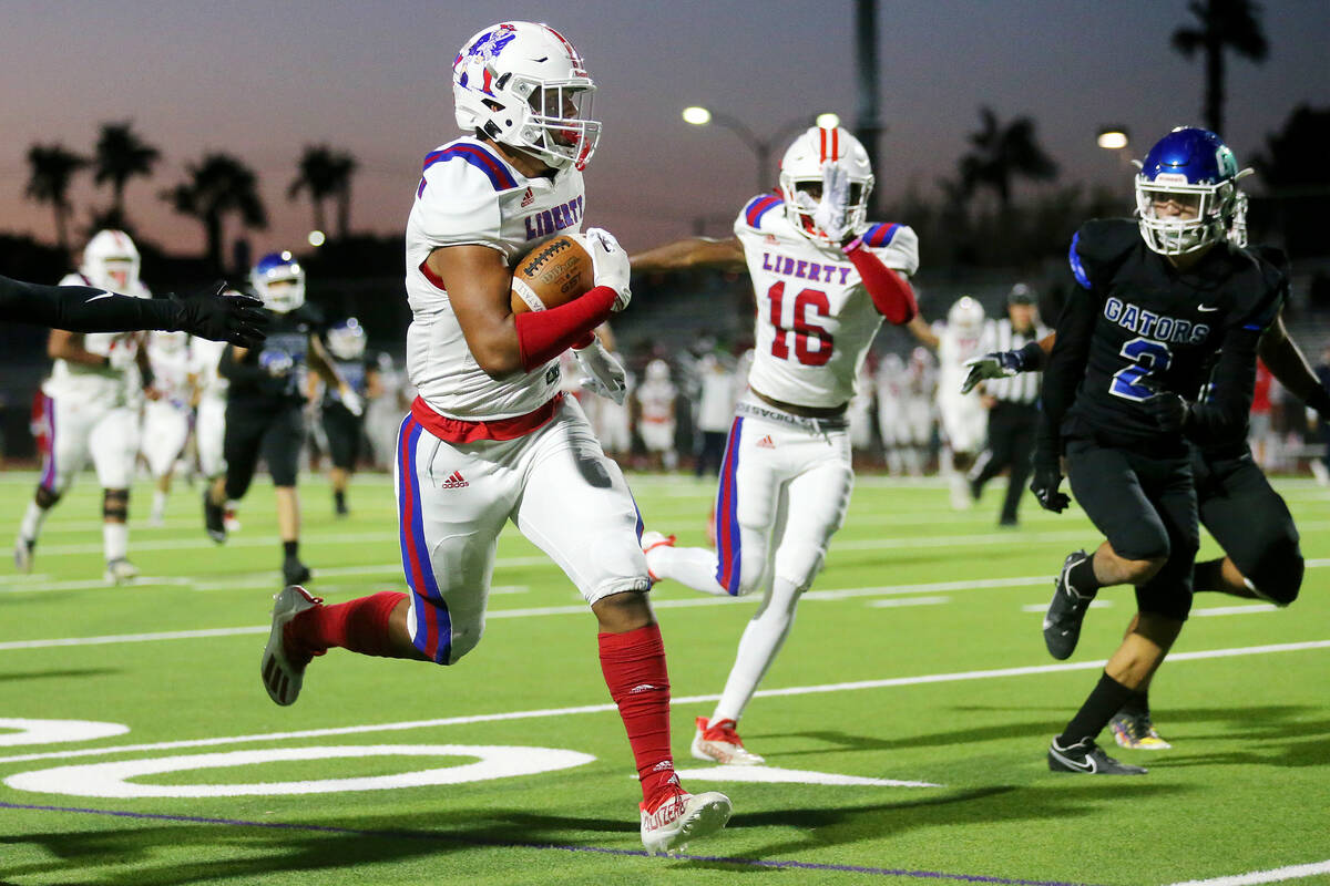 Liberty's Anthony Jones (5) runs the ball after a catch for a touchdown in the first half of a ...