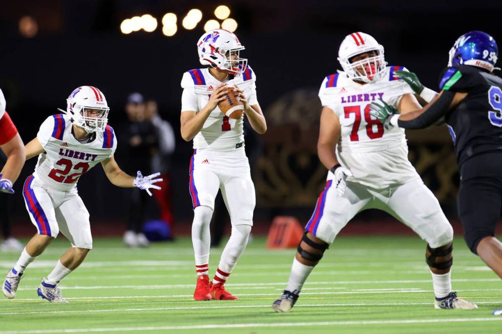 Liberty's Jayden Maiava (1) looks for an open pass in the first half of a football game against ...