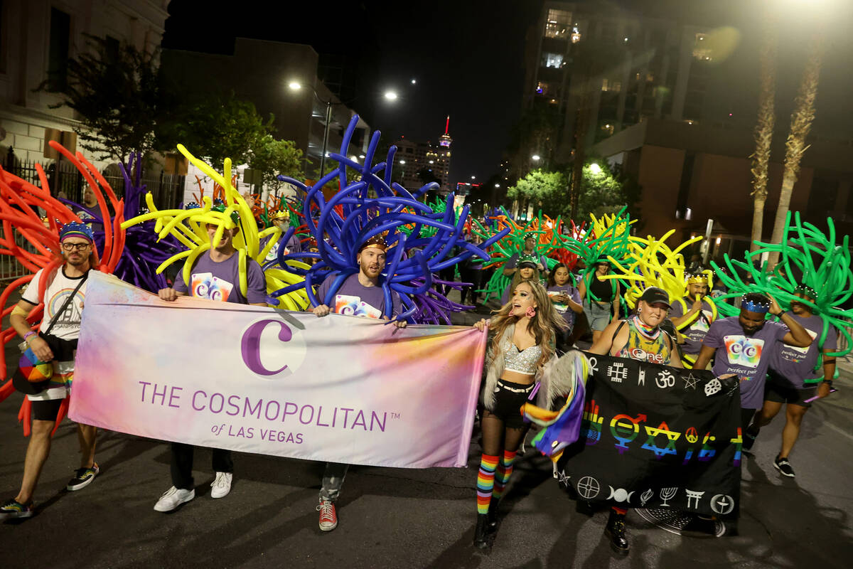 Members of The Cosmopolitan of Las Vegas entry march in the Las Vegas Pride Night parade downto ...