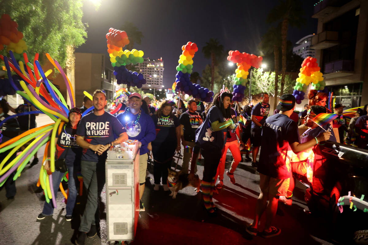 Members of the Delta Airlines entry march in the Las Vegas Pride Night parade downtown Friday, ...