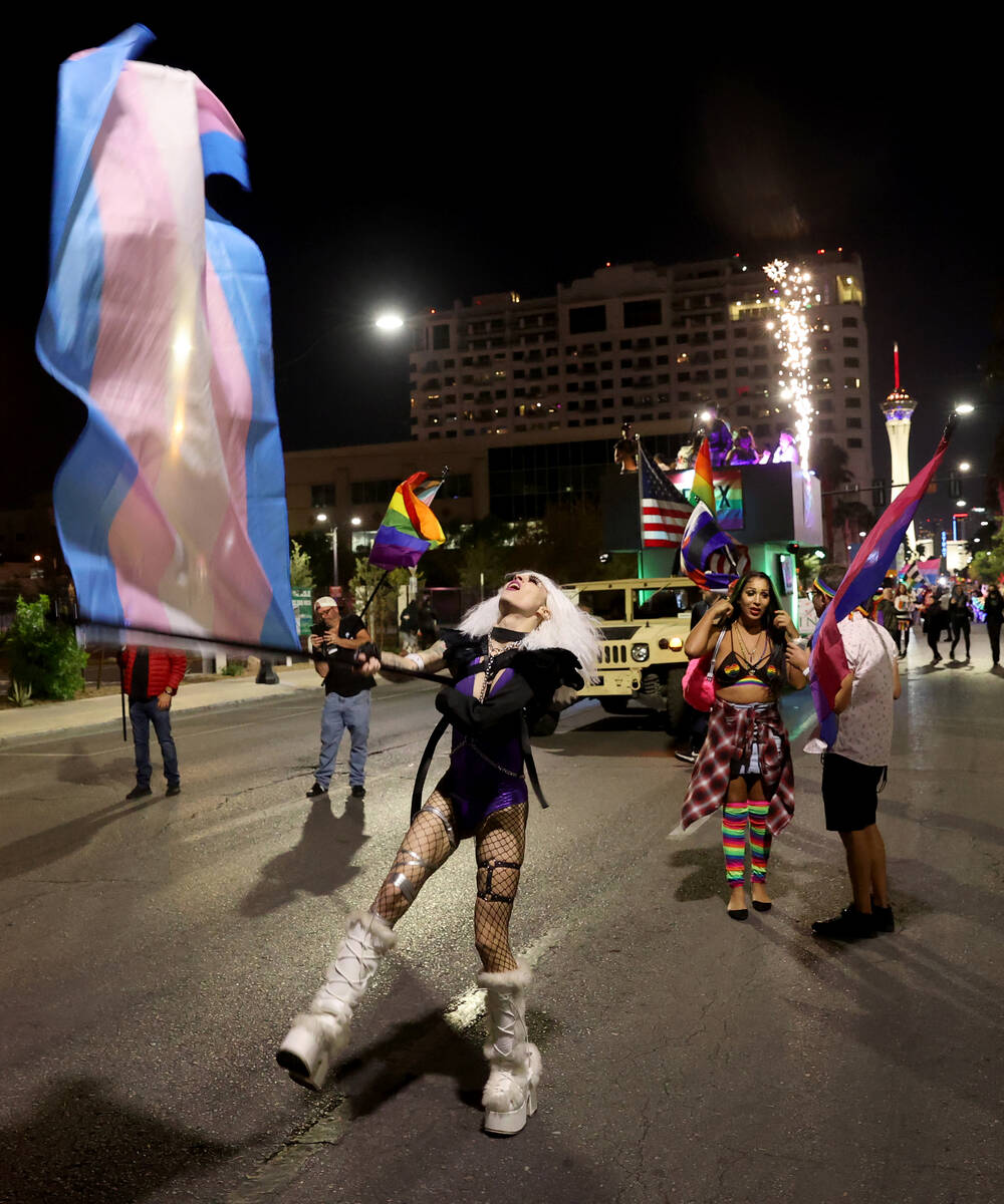 Members of Flex Cocktail Lounge entry march in the Las Vegas Pride Night parade downtown Friday ...