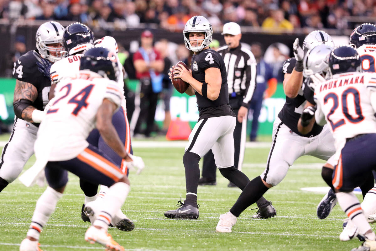 Oakland Raiders quarterback Derek Carr (4) drops back to pass during the first half of an NFL g ...