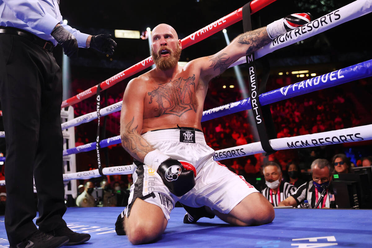 Robert Helenius kneels after getting hit with a low blow by Adam Kownacki in the third round of ...