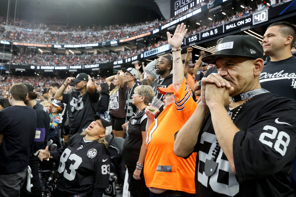 Fans, including Raiders fan Johnny Flores of Fontana, Calif., right, and Bears fan Lisa Parrish ...