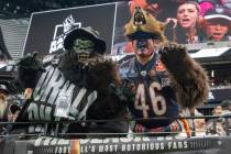 Raiders superfan Gorilla Rilla poses with a Bears fan before an NFL football game on Sunday, Oc ...