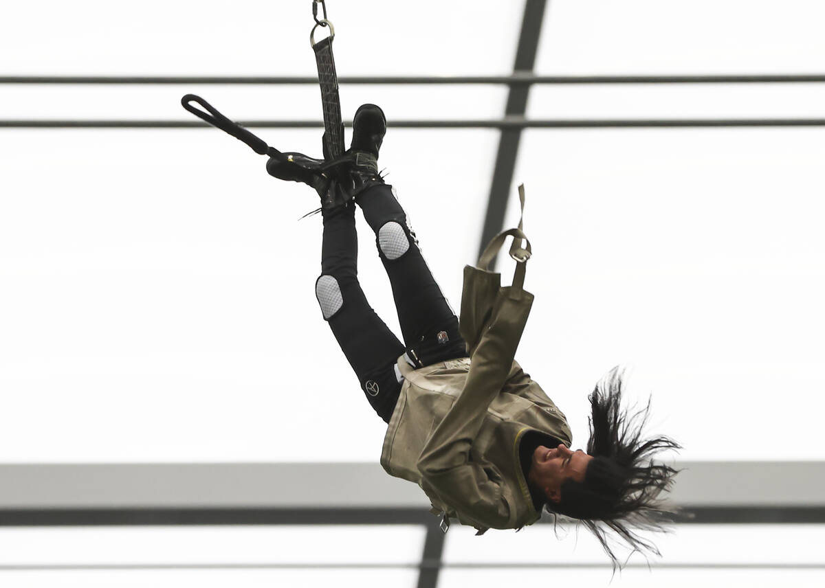 Magician and "Mindfreak" star Criss Angel, dangling over 100 feet in the air in Alleg ...