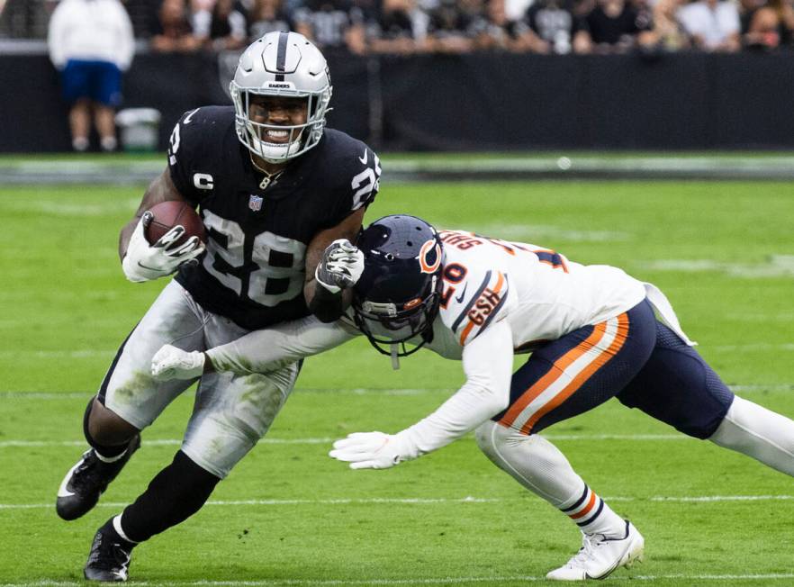 Raiders running back Josh Jacobs (28) eludes Chicago Bears cornerback Duke Shelley (20) during ...