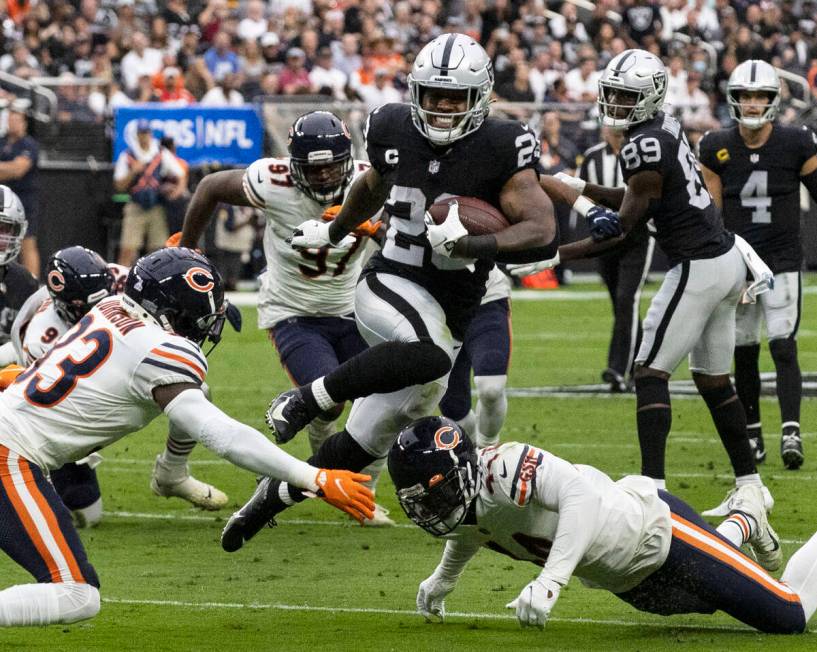 Raiders running back Josh Jacobs (28) eludes Chicago Bears defenders during the second half of ...