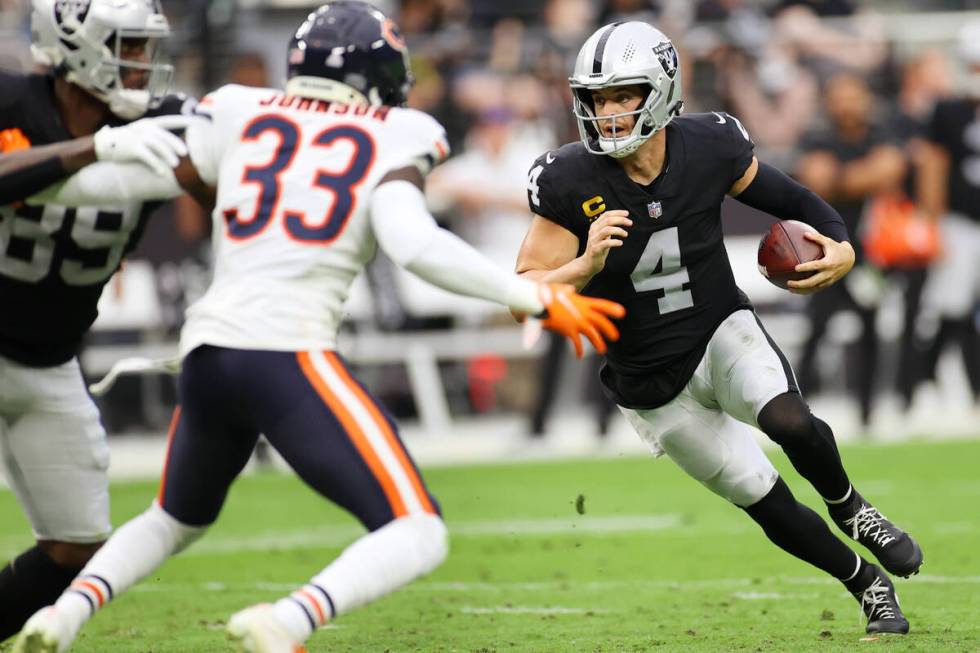 Raiders quarterback Derek Carr (4) runs the ball during the first half of an NFL football game ...