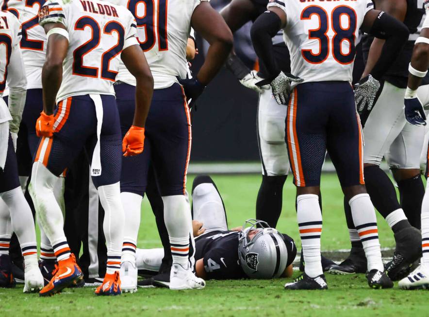 Raiders quarterback Derek Carr (4) lies on the ground after an injury during the second half of ...