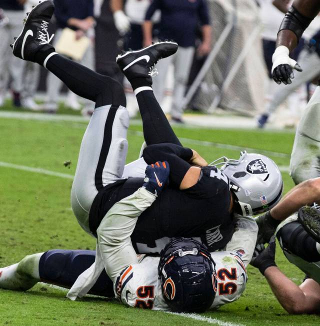 Raiders quarterback Derek Carr (4) sucked by Chicago Bears outside linebacker Khalil Mack (52) ...