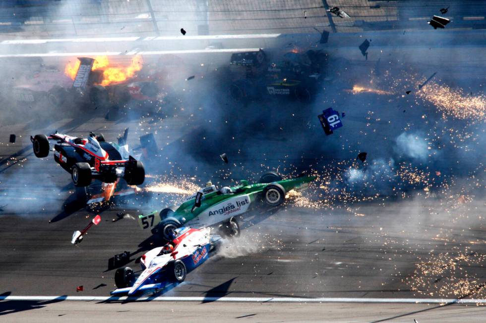 IndyCars slam together in a massive crash during the IZOD IndyCar World Championship at the Las ...