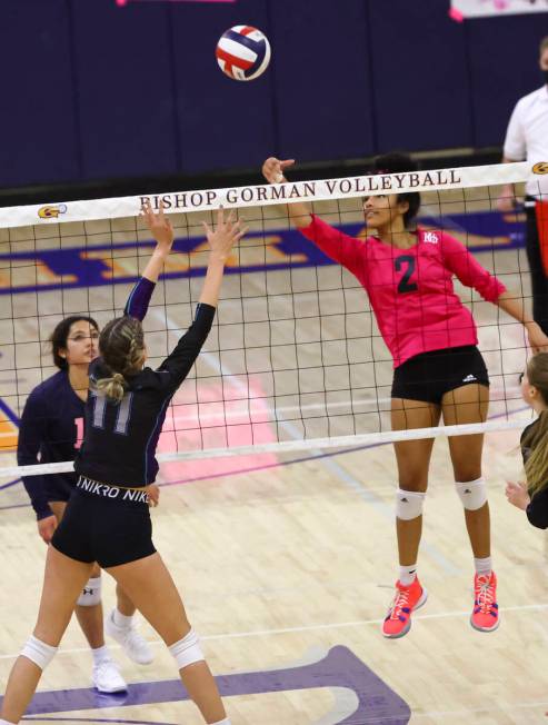 Silverado's Jenna Desellems (11) and Bishop Gorman's Sophia Ewalefo (2) reach for the ball duri ...