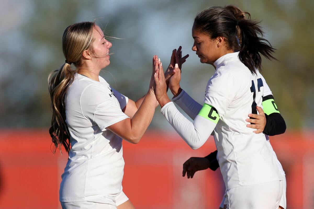 Centennial's Syrena Taylor (13), right, celebrates a goal with Savannah Walers (18) during the ...