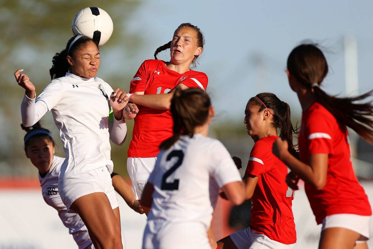 Centennial's Syrena Taylor (13) and Arbor View's Alexis Romeo (18) jump for the ball during a C ...