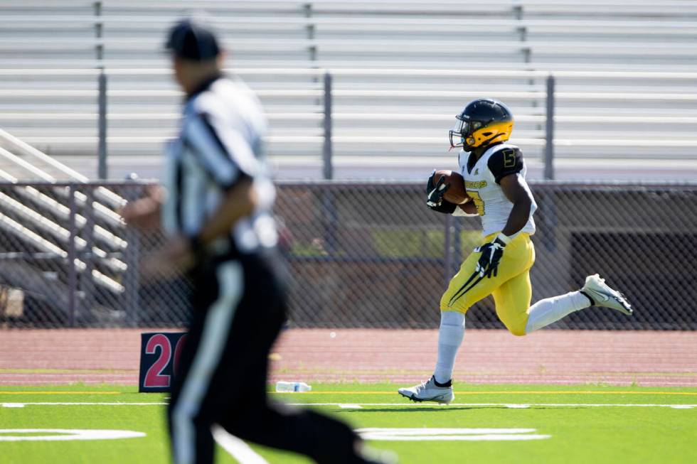 Clark running back D'on Williams (5) runs toward the end zone for a touchdown against Cheyenne ...