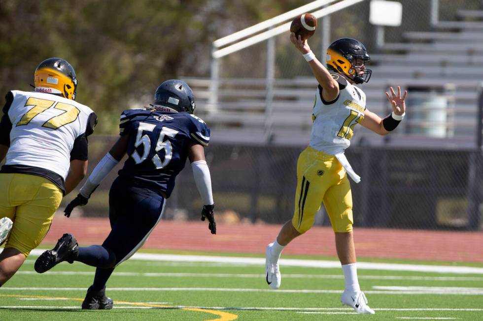 Clark quarterback Mason King (12) passes as Cheyenne defensive lineman Javon Holloway (55) and ...