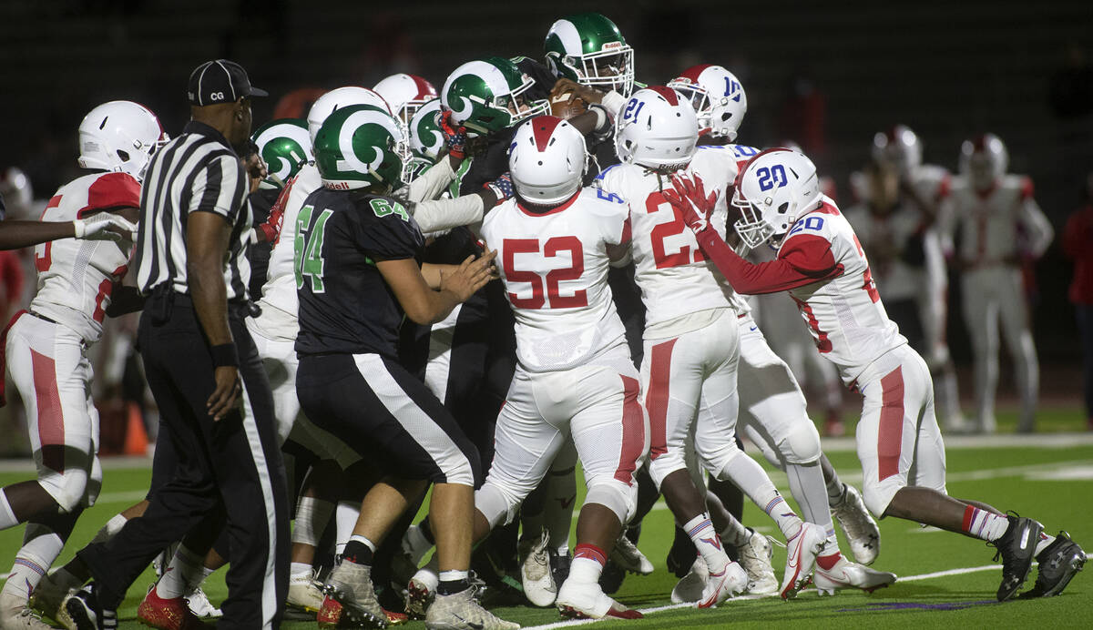 In the middle of the scrum, Rancho's running back Malik McHugh (41) carries the ball 18 yards d ...