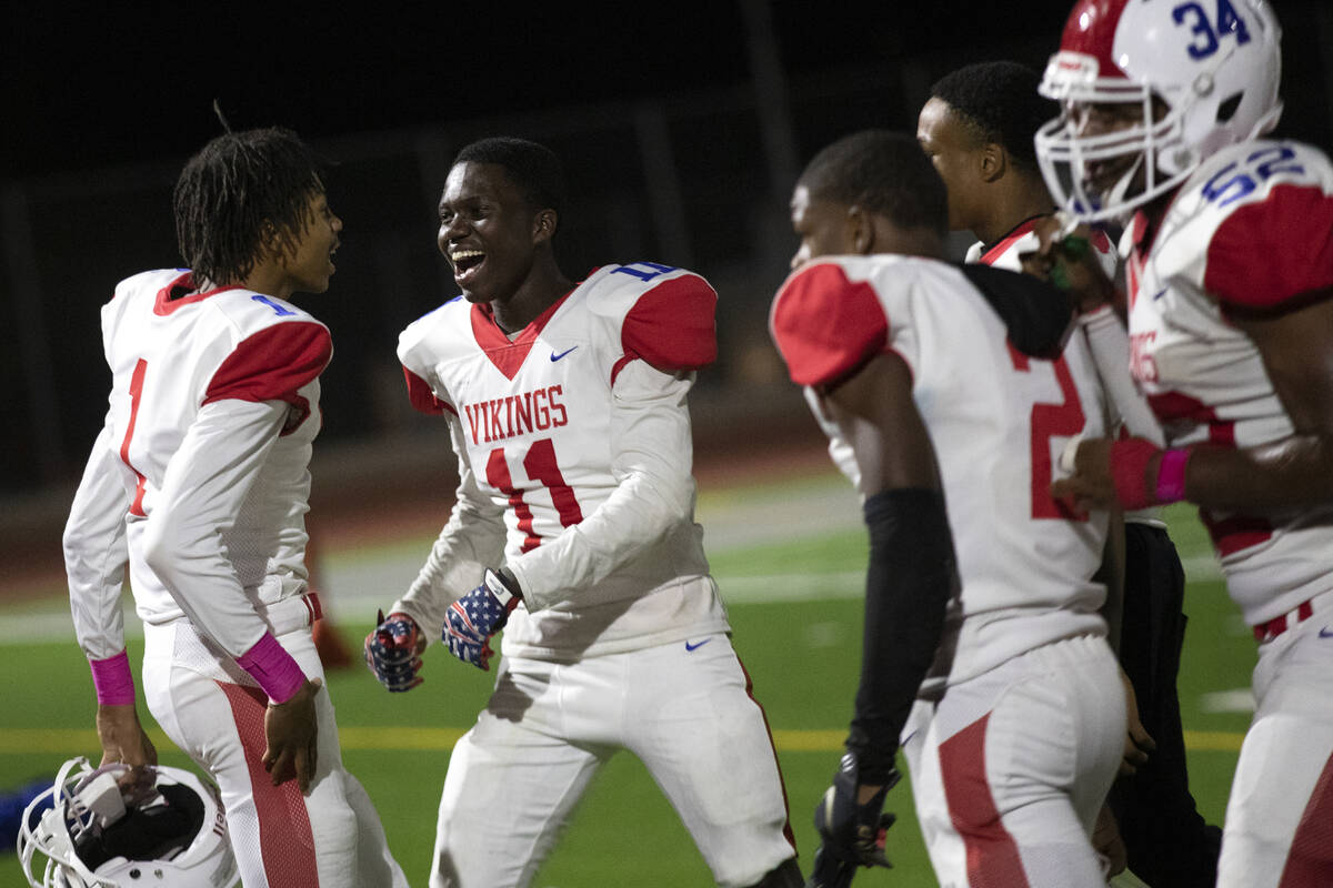 Valley's Tyler Searcy (1) and Joathan Minani (11) celebrate a win against Rancho in a high scho ...