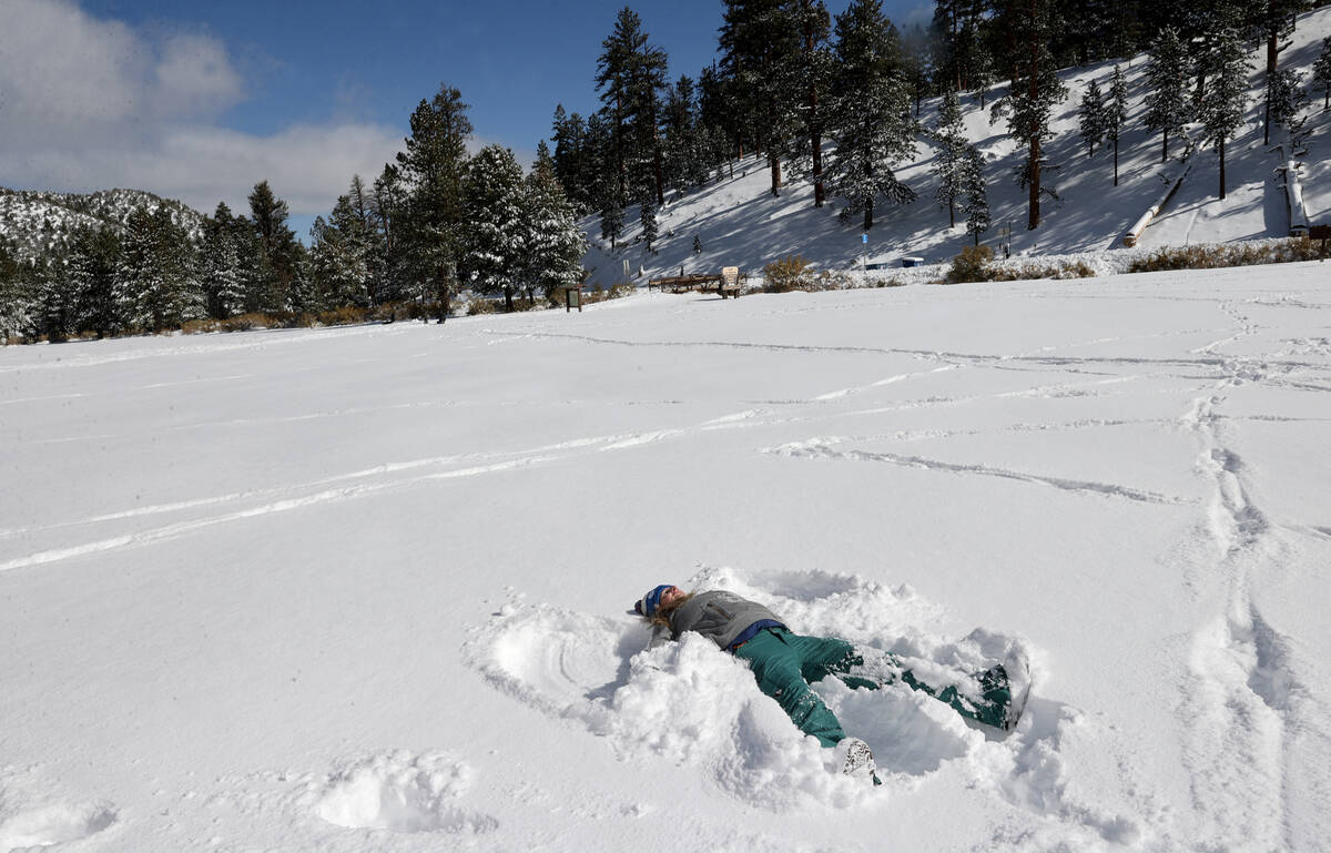 Amy Parker of Las Vegas makes a snow angel in freshly fallen snow in Upper Lee Meadows on Mount ...