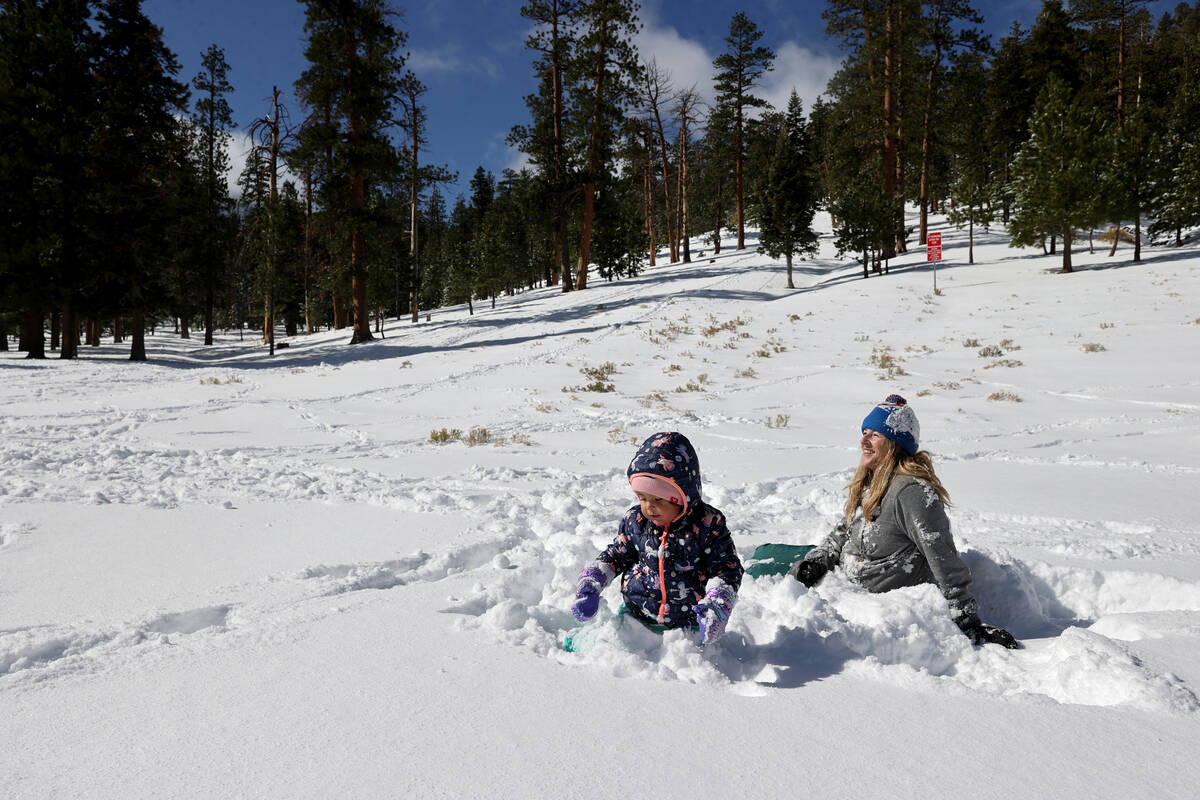 Ava Parker, 2, and her mom Amy of Las Vegas play in freshly fallen snow in Upper Lee Meadows on ...