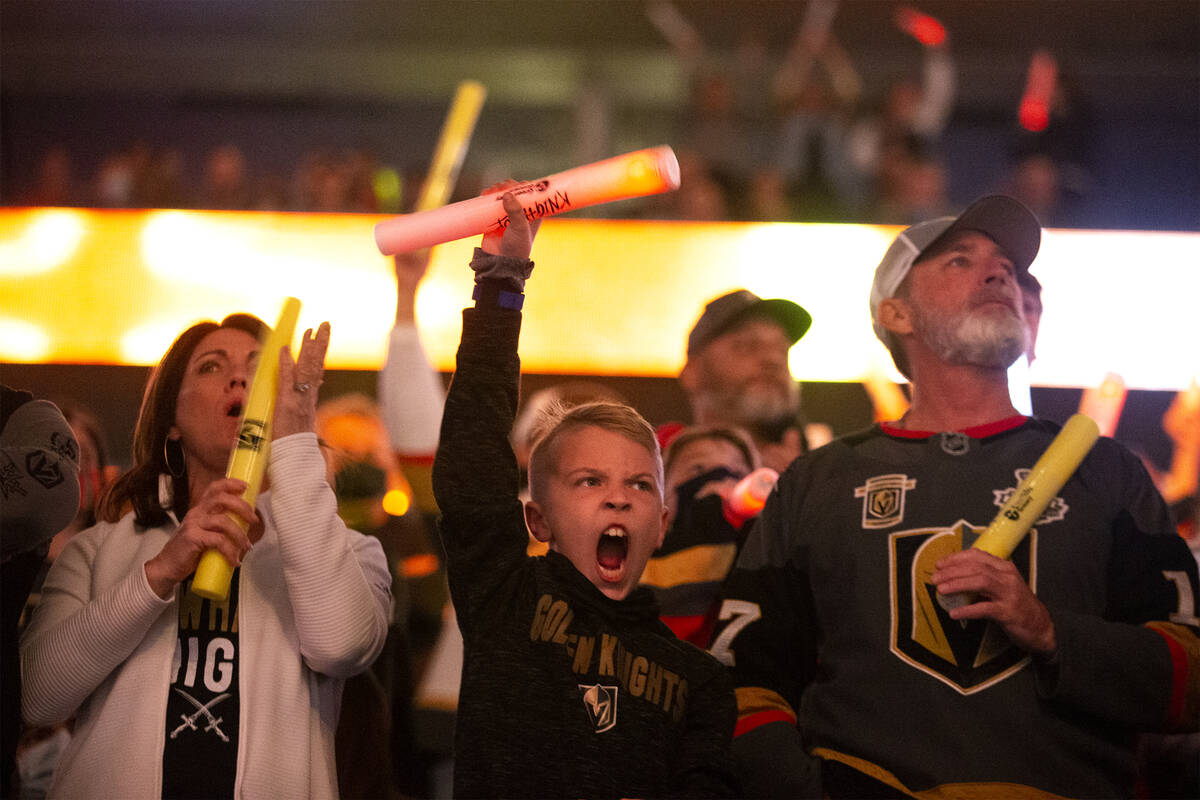 Fans cheer as the Golden Knights take the ice before the first period during an NHL hockey game ...