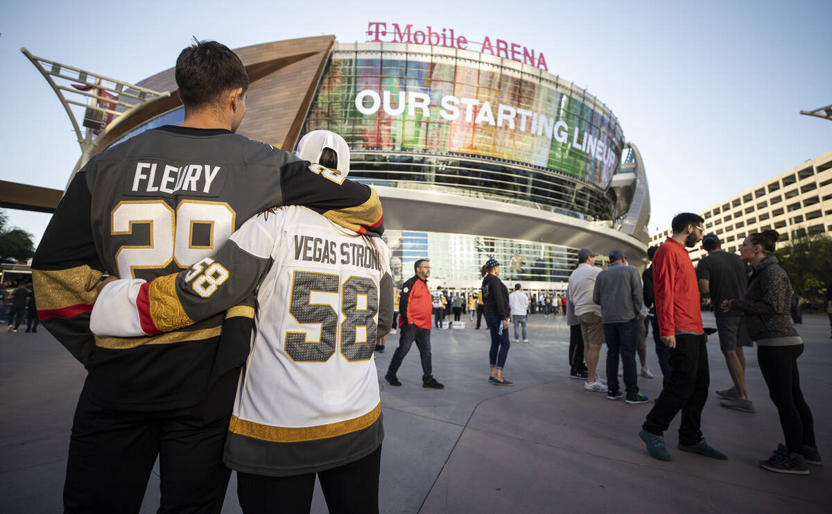Daniel and Debrah Escobedo, of Las Vegas, share a hug before the start of an NHL hockey ga ...