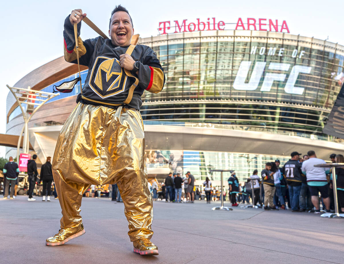 Golden Knights fan Eve Gizelbach dances outside before the start of an NHL hockey game against ...