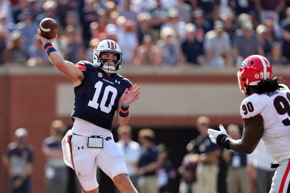 Auburn quarterback Bo Nix (10) throws a pass against Georgia during the first half of an NCAA c ...