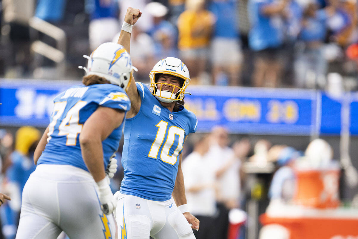 Los Angeles Chargers quarterback Justin Herbert (10) celebrates his touchdown pass during an NF ...